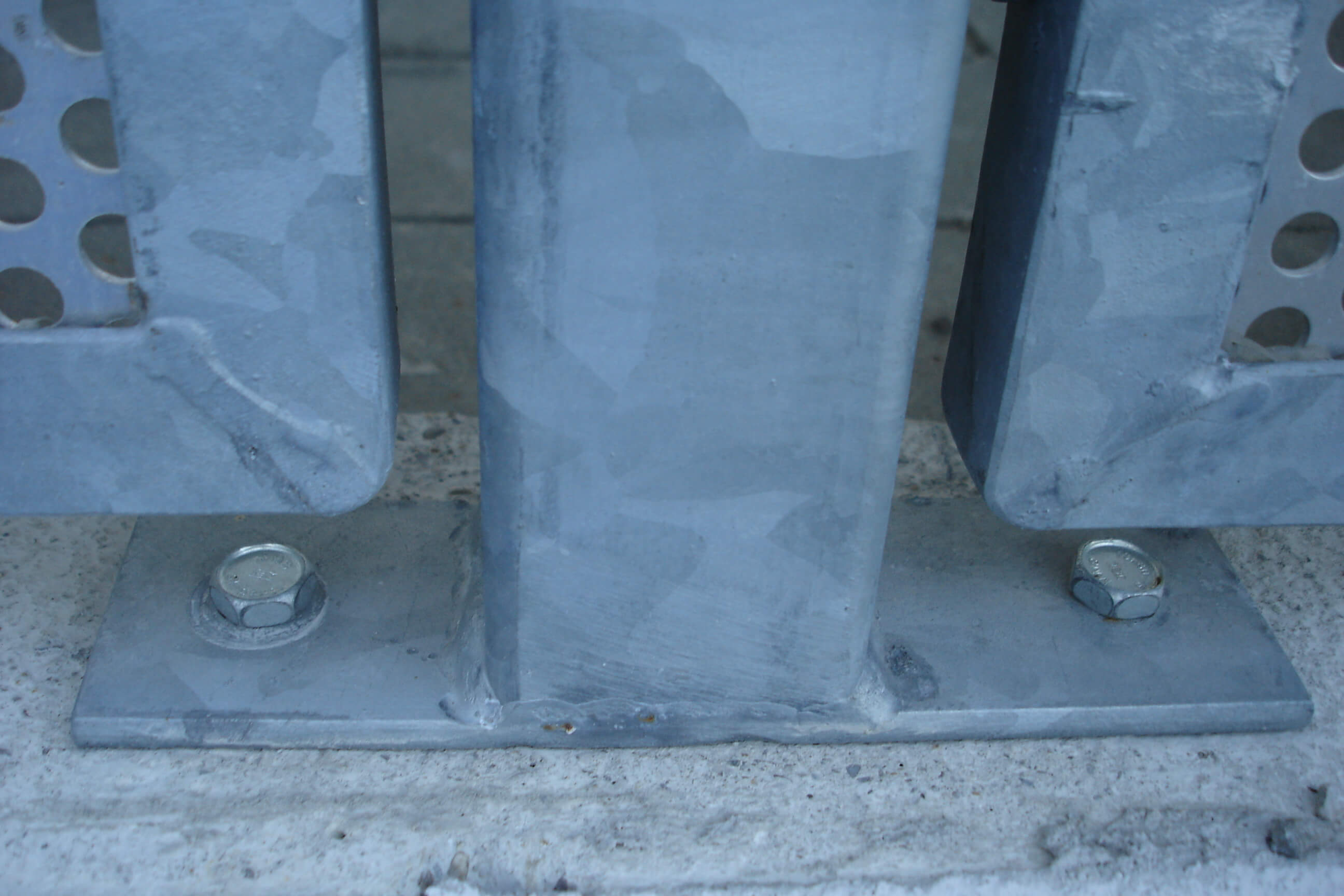 Betonschraube, die zur Befestigung eines Metallgeländers an einem Betonboden verwendet wird