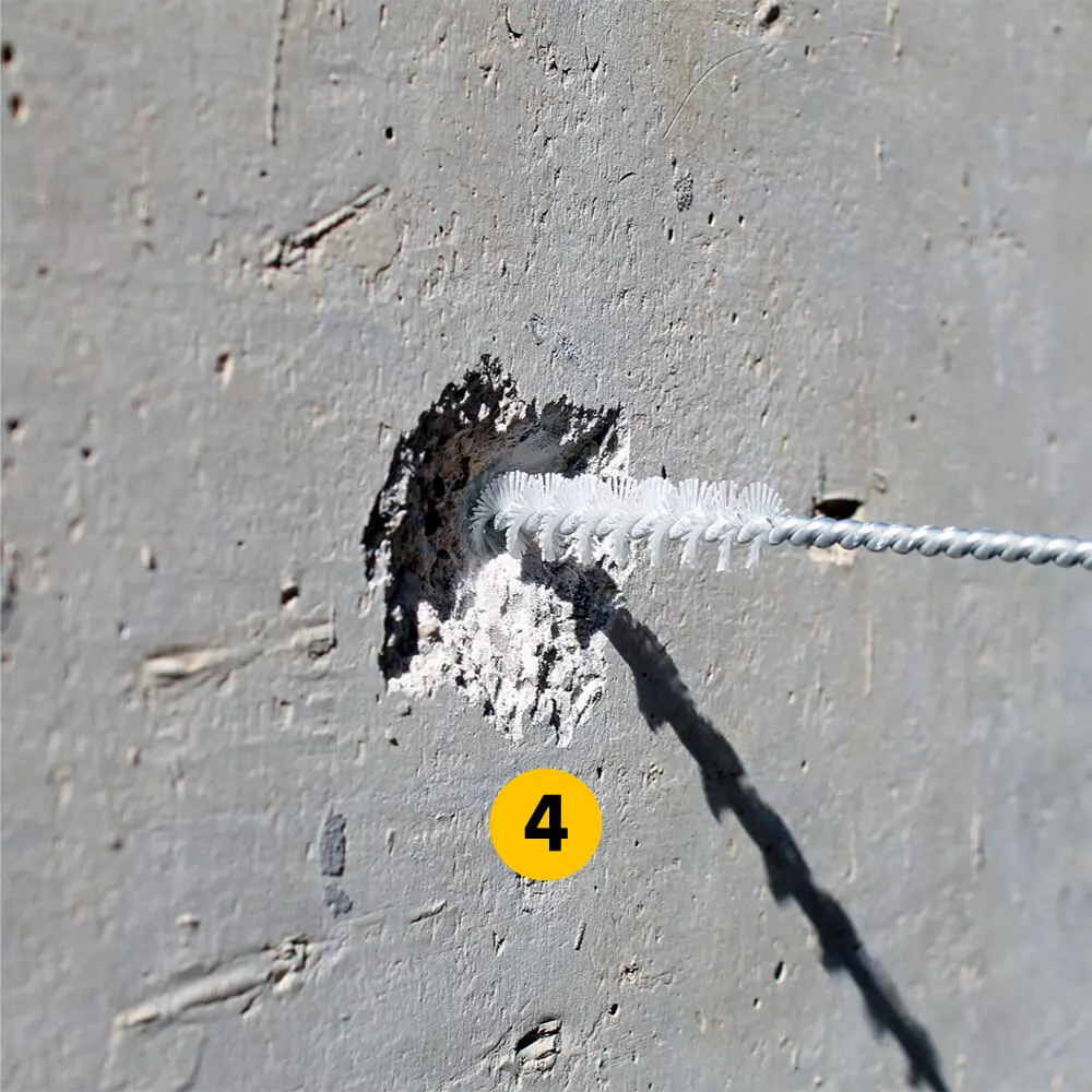 Das entstandene Bohrloch ausbürsten und ausblasen und so von Bohrmehl befreien